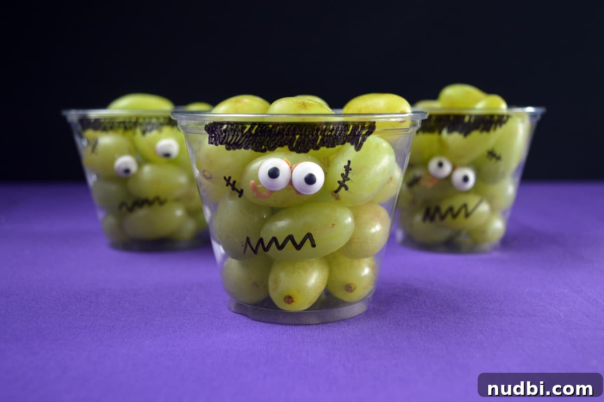 Frankenstein grape cups with green grapes and drawn faces.