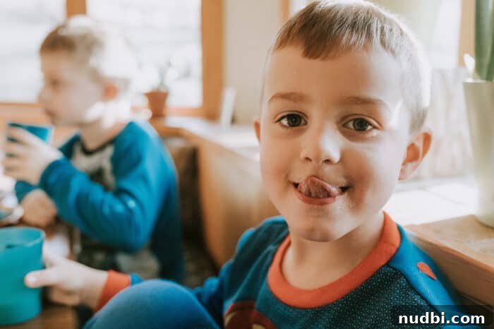 A parent and child sharing a joyful, relaxed meal, illustrating a 'lighten up' approach to eating.