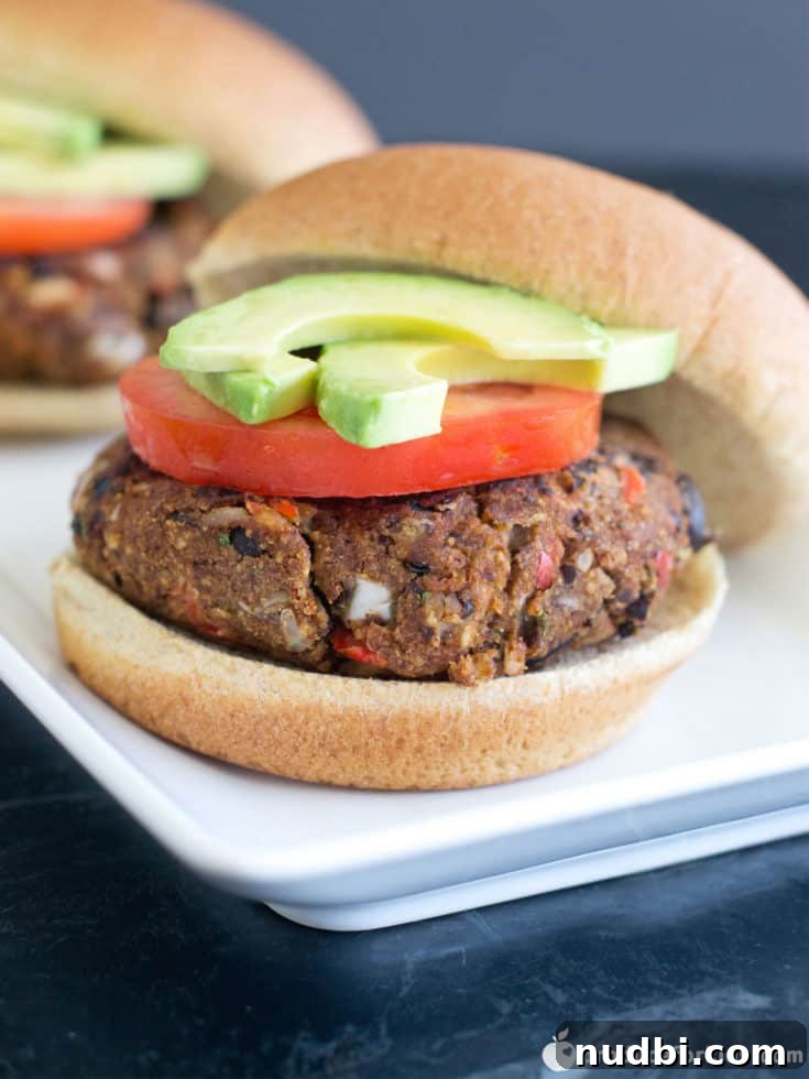 Hearty Southwest Black Bean Burgers on buns with fresh toppings.