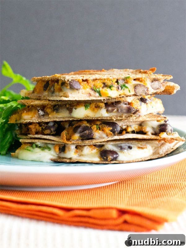 A savory Sweet Potato & Black Bean Quesadilla, cut into wedges.