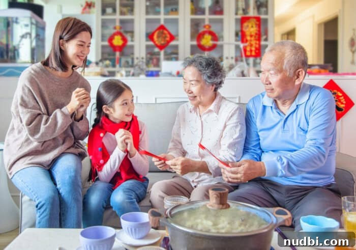 Happy Asian family celebrating Chinese New Year at home, sharing a meal and traditional customs.