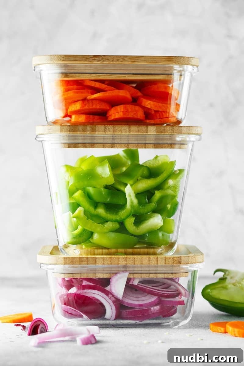meal planning containers Various meal planning containers with chopped vegetables, ready for cooking or eating.