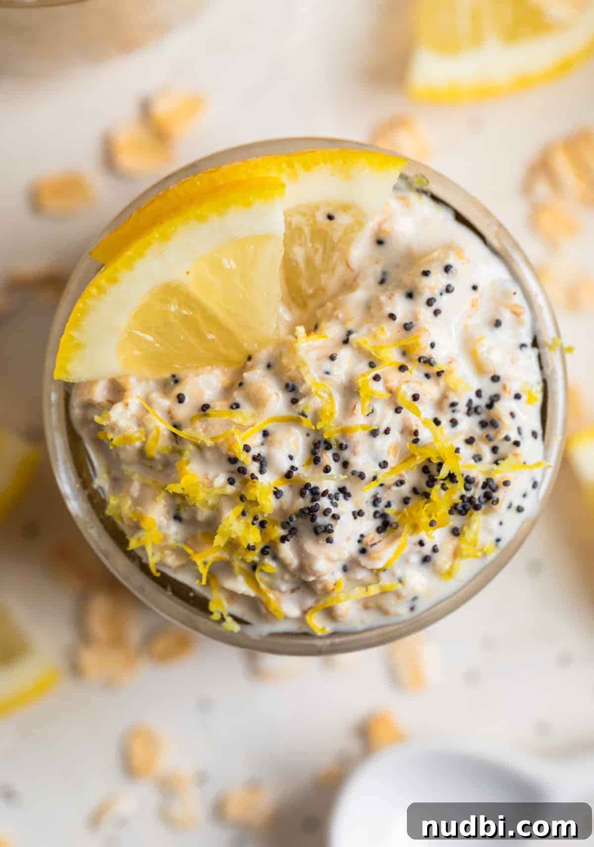 Lemon Poppy Seed Overnight Oats Recipe for Bright Morning Meals 3 Overhead view of glass jar with lemon oatmeal topped with poppy seeds.