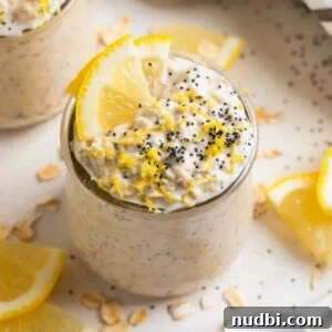 Lemon Poppy Seed Overnight Oats Recipe for Bright Morning Meals 7 Lemon poppy seed overnight oatmeal in glass jar with lemon slices and poppy seeds on top for garnish.
