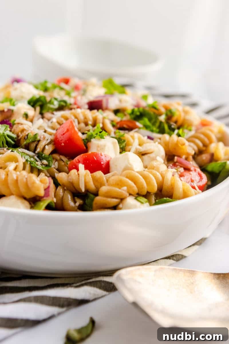 10 Refreshing Summer Salads and Sides for Your Next BBQ 2 Tomato basil pasta salad in bowl.