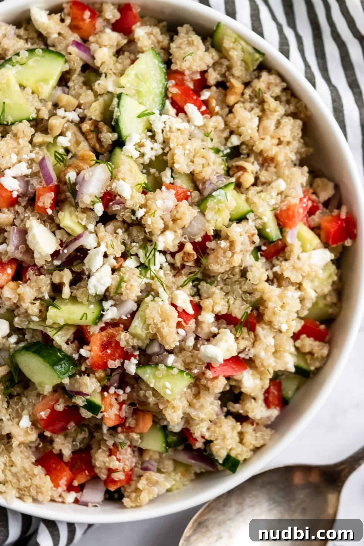 10 Refreshing Summer Salads and Sides for Your Next BBQ 6 Cucumber Feta salad in white bowl.