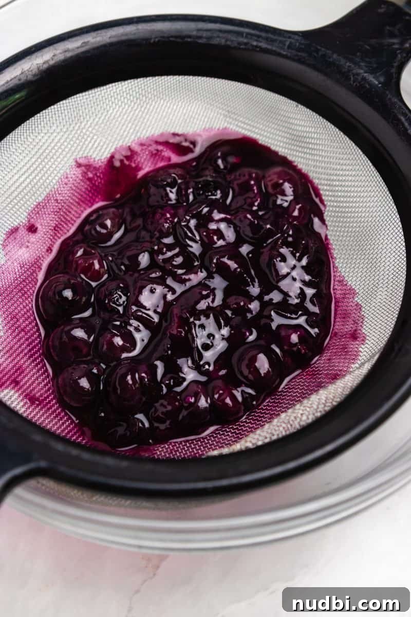 Blueberry, Basil & Goat Cheese Grilled Sandwich Recipe 4 Blueberry sauce in strainer.