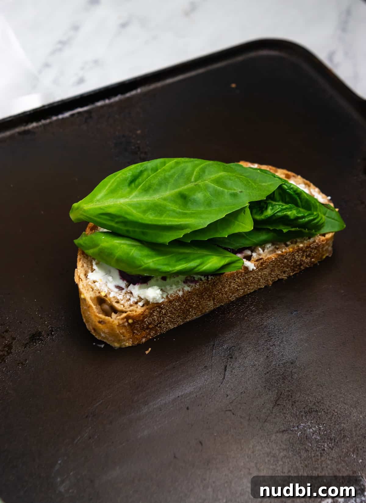 Blueberry, Basil & Goat Cheese Grilled Sandwich Recipe 6 Basil on grilled cheese sandwich on skillet.
