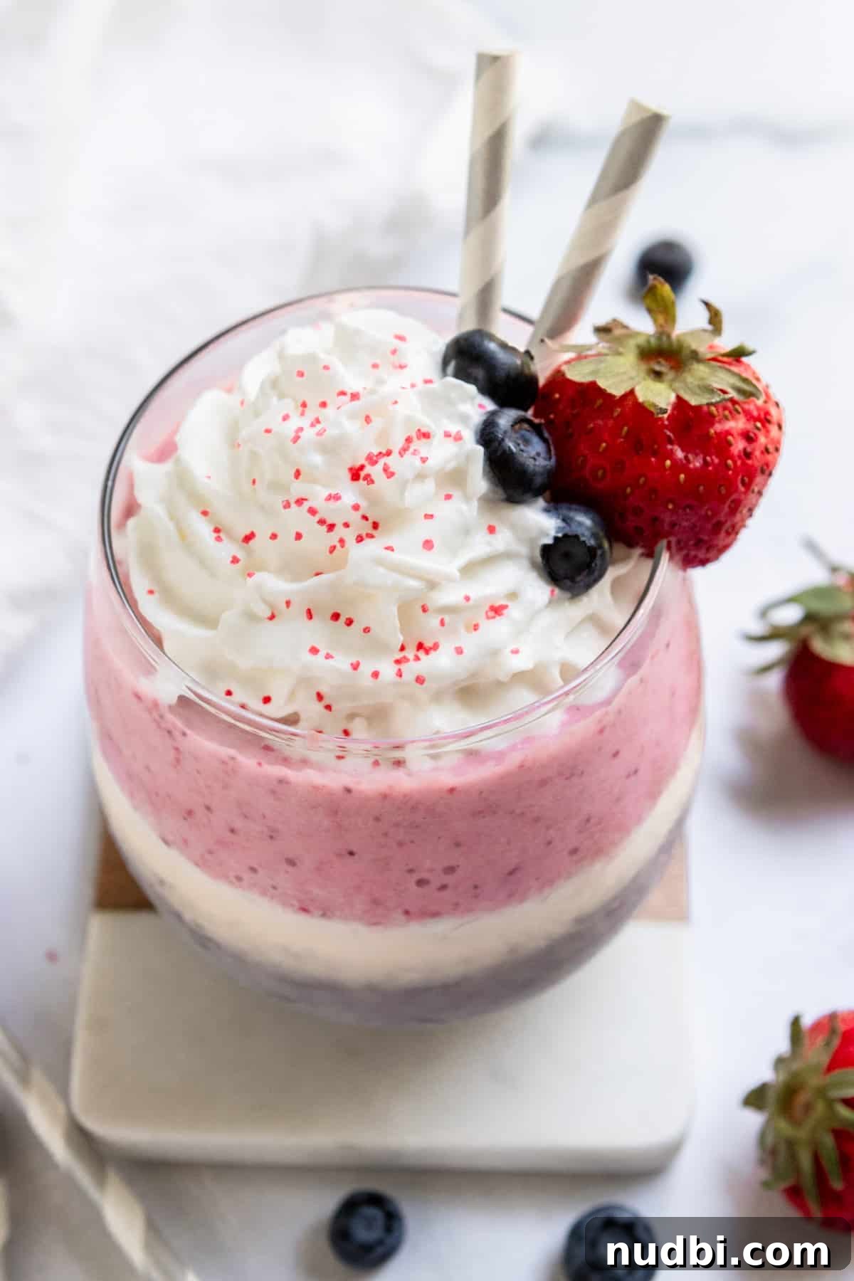 Patriotic Red, White & Blue Milkshake Recipe for Summer Celebrations 2 Red white and blue milkshake with whipped cream and fruit.