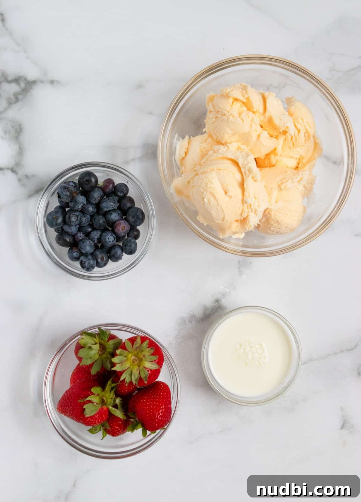 Patriotic Red, White & Blue Milkshake Recipe for Summer Celebrations 3 vanilla ice cream, milk and berries on counter.