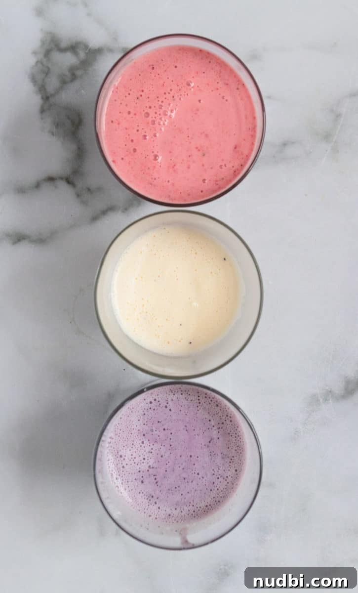 Patriotic Red, White & Blue Milkshake Recipe for Summer Celebrations 4 Red, white and blue milkshakes in glass.