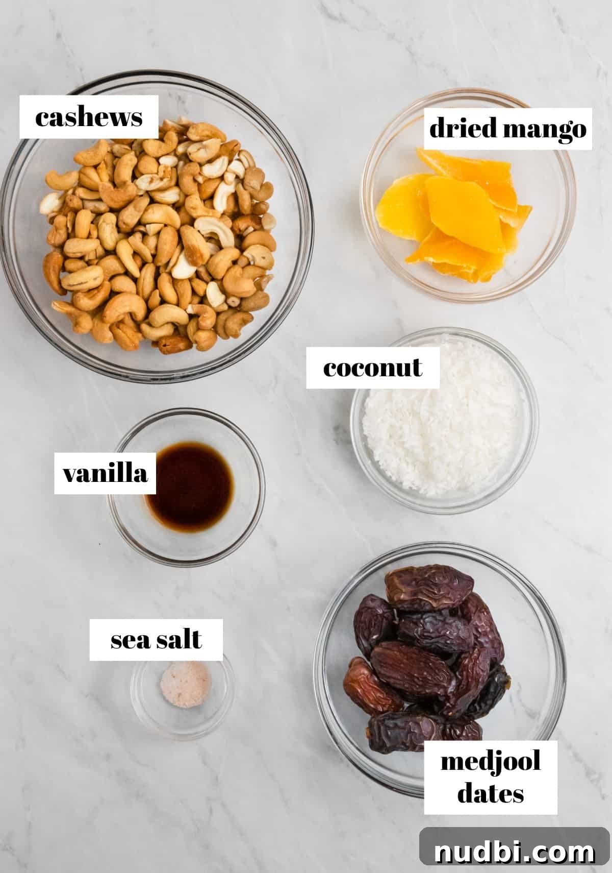 Coconut Mango Energy Bites: Tropical No-Bake Snack Recipe 3 Cashews, mango, medjool dates and other ingredients on counter.