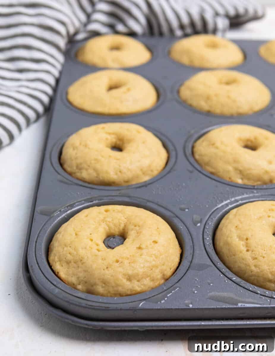 Triple Vanilla Donuts Recipe: Soft, Fluffy, and Extra Vanilla 6 Baked donuts in baking pan.