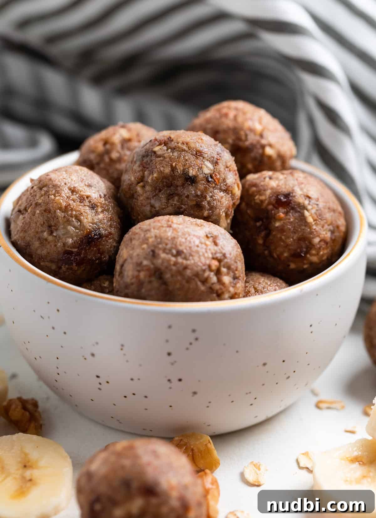 No-Bake Banana Bread Bites Recipe – Quick No-Oven Snack 8 Banana oat balls in bowl with linen behind.