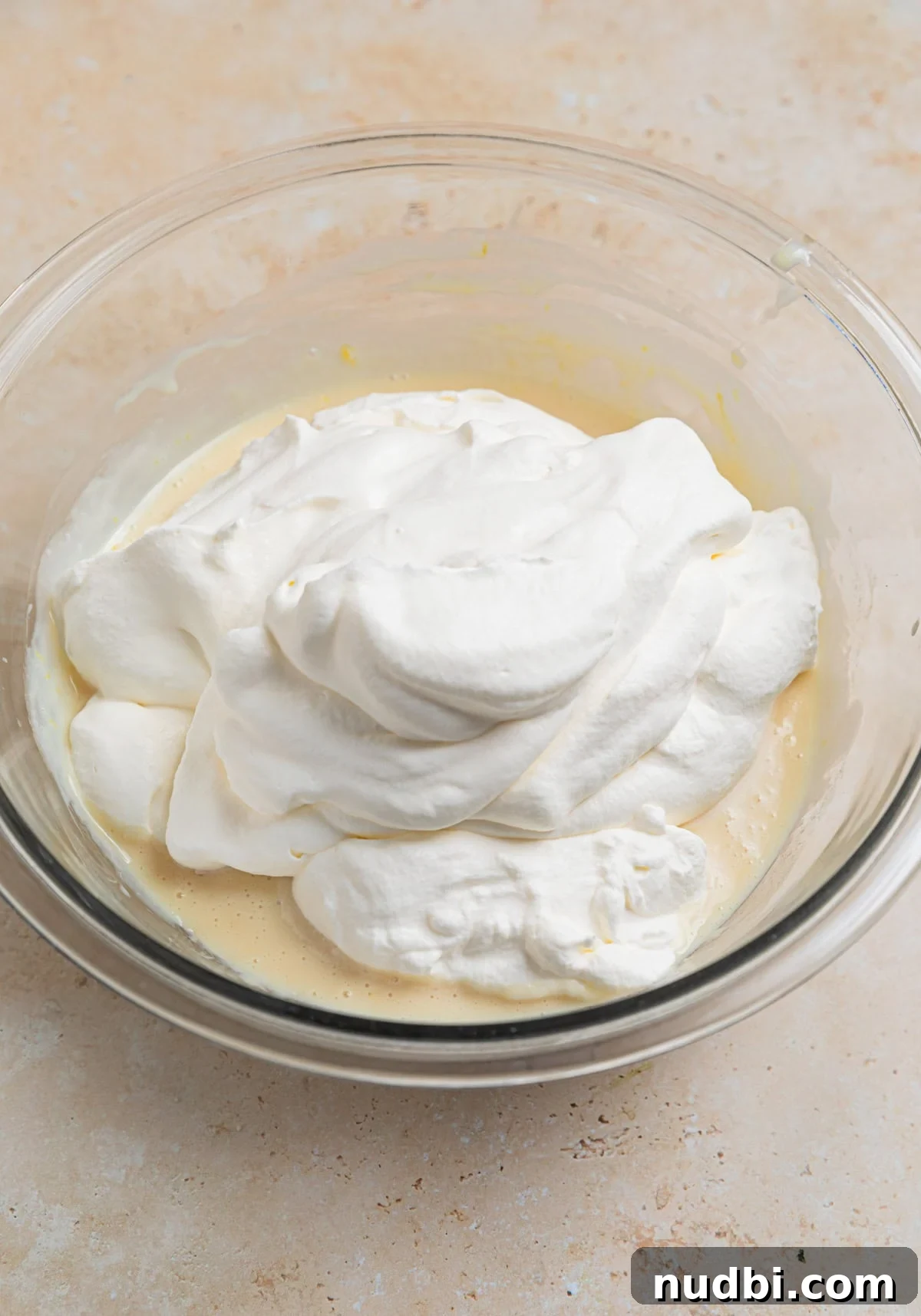 No-Churn Lemon Ice Cream Recipe — Creamy, Tart & Refreshing 6 Whipped cream and condensed milk mixture in glass mixing bowl.