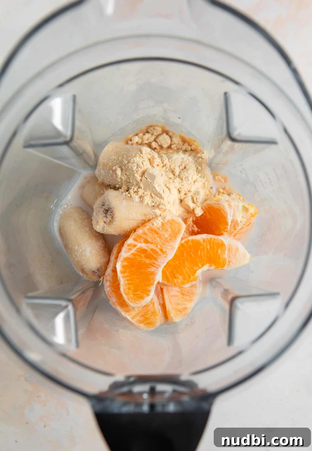 Orange Creamsicle Protein Smoothie Recipe for Creamy Vitamin C Boost 3 Orange, banana, milk and protein powder in blender.