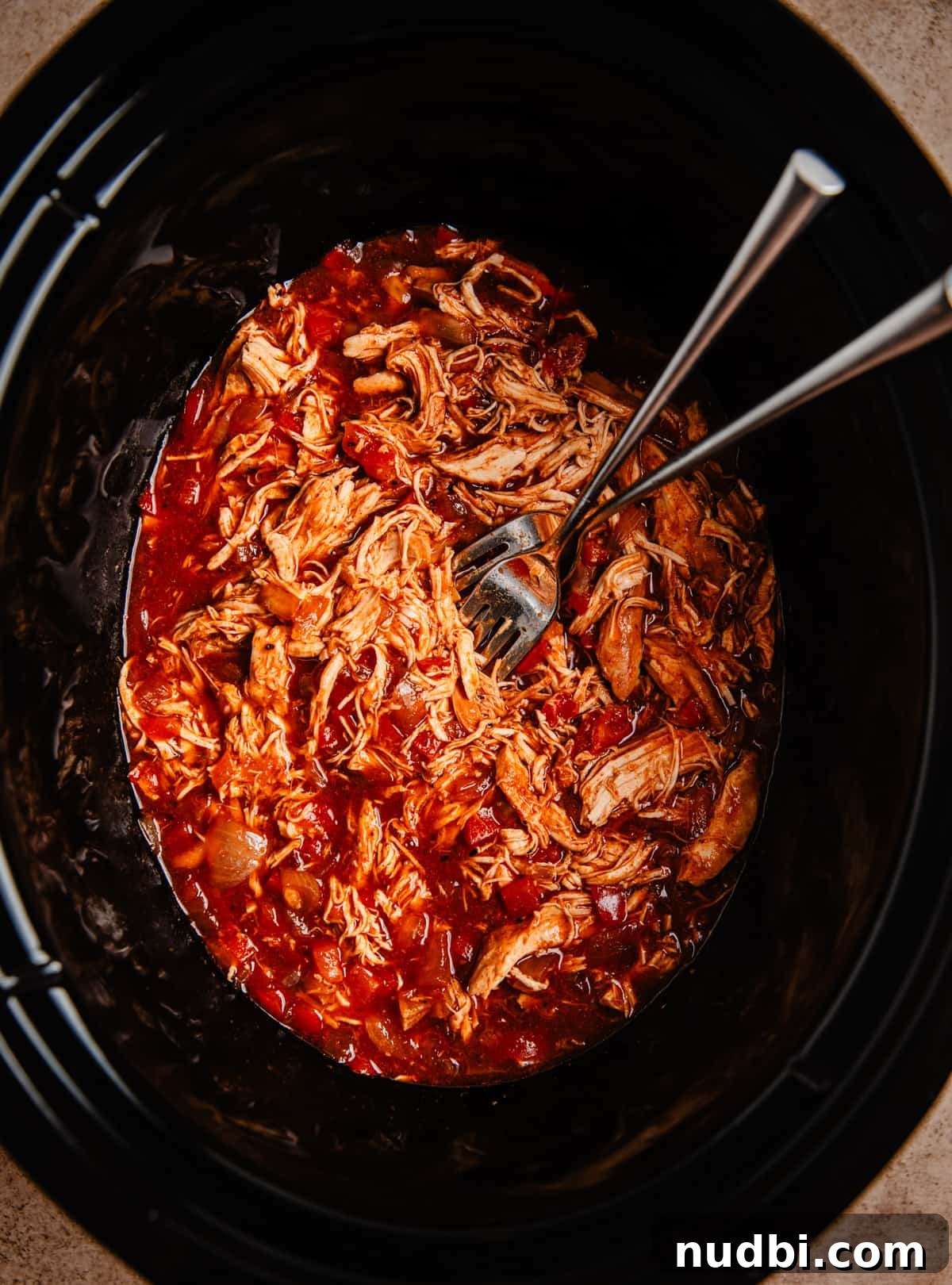 Slow Cooker BBQ Shredded Chicken Recipe for Sandwiches and Tacos 7 Shredded BBQ chicken with forks in slow cooker pot.