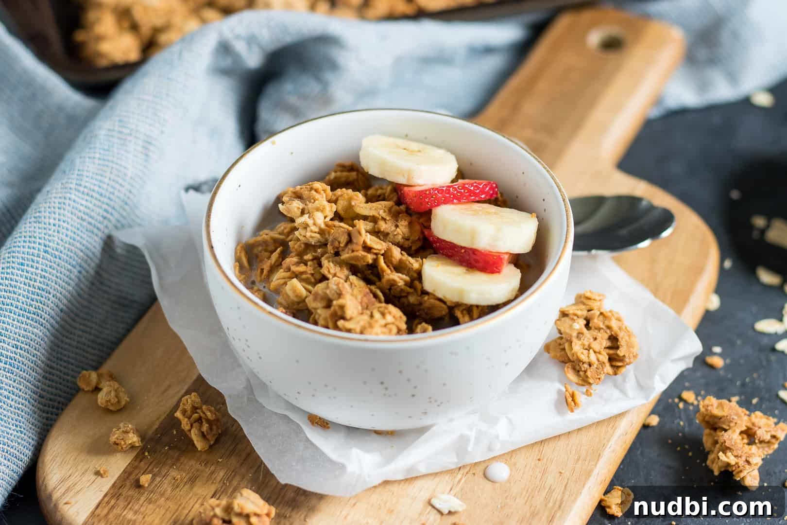 Crunchy Peanut Butter Granola Recipe for Homemade Mornings 3 Peanut butter granola in bowl with banana and strawberry slices.