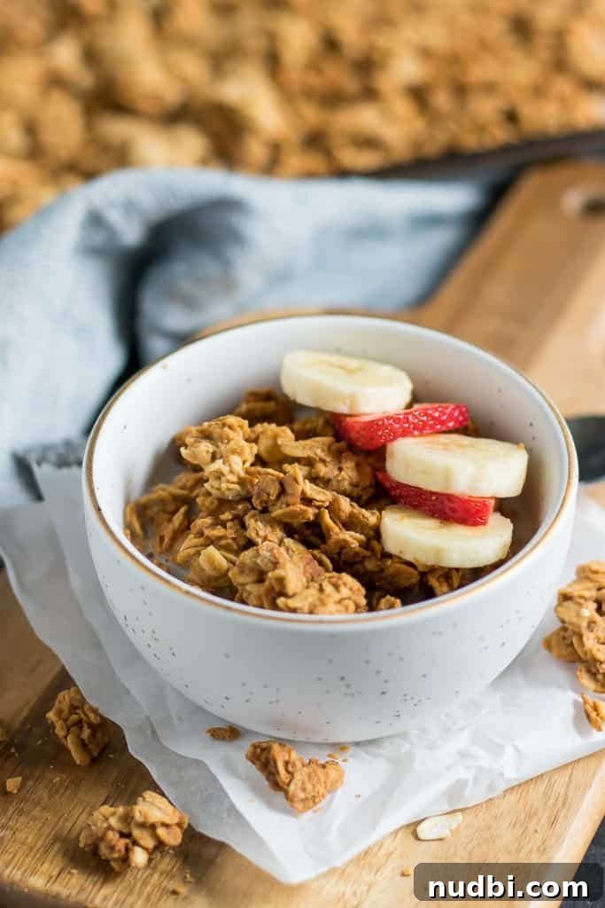 Crunchy Peanut Butter Granola Recipe for Homemade Mornings 4 Peanut Butter Granola in bowl with banana and strawberry slices.