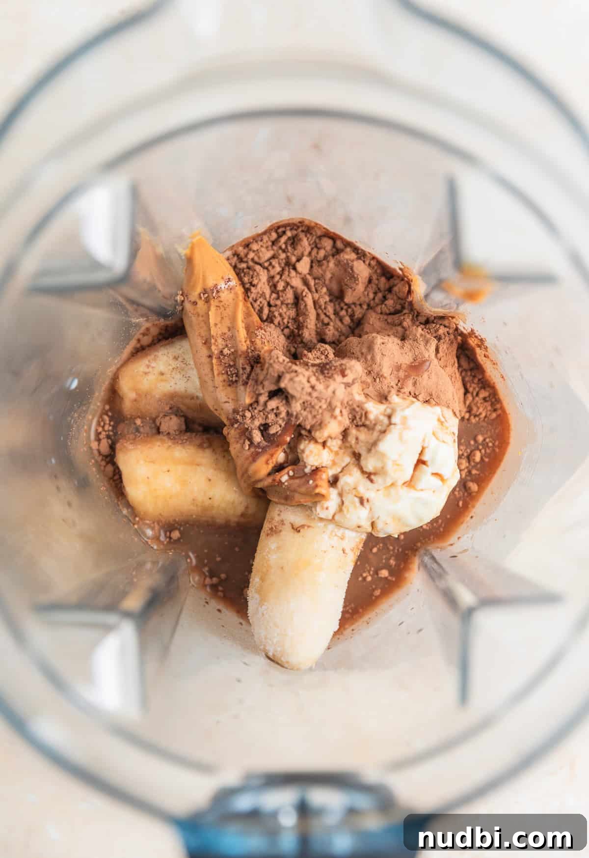 Peanut Butter Coffee Smoothie Recipe — Creamy Protein Boost 4 Frozen bananas, cocoa powder, yogurt, peanut butter and coffee in blender.
