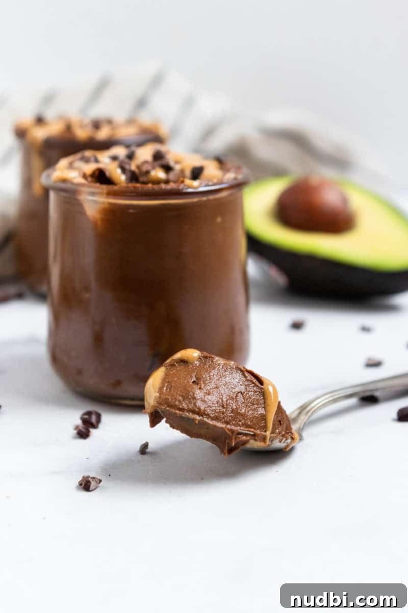 Peanut Butter Chocolate Avocado Mousse Recipe for Creamy Desserts 3 Shot of spoonful of mousse with peanut butter.