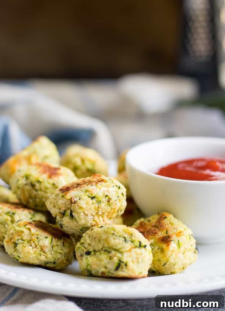 Cheesy Zucchini Tots: Crispy Baked Veggie Potato Bites 5 These Cheesy Zucchini Tots are a fun way to get the family to eat some veggies with a smile! They are simple to whip up and perfect for dipping into your favorite sauce!
