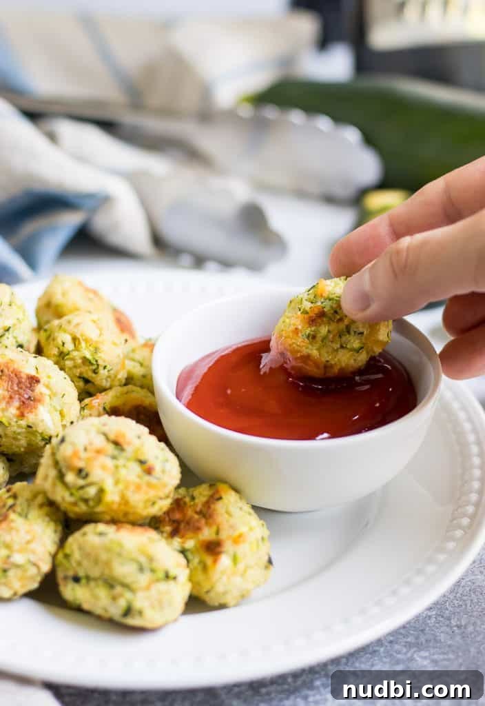 Cheesy Zucchini Tots: Crispy Baked Veggie Potato Bites 6 These Cheesy Zucchini Tots are a fun way to get the family to eat some veggies with a smile! They are simple to whip up and perfect for dipping into your favorite sauce!