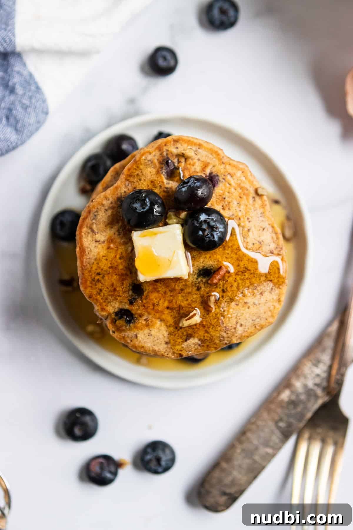 Whole Wheat Blueberry Pancakes with Flaxseed (Fiber-Rich Recipe) 3 Overhead shot of flax pancakes with fork and knife.
