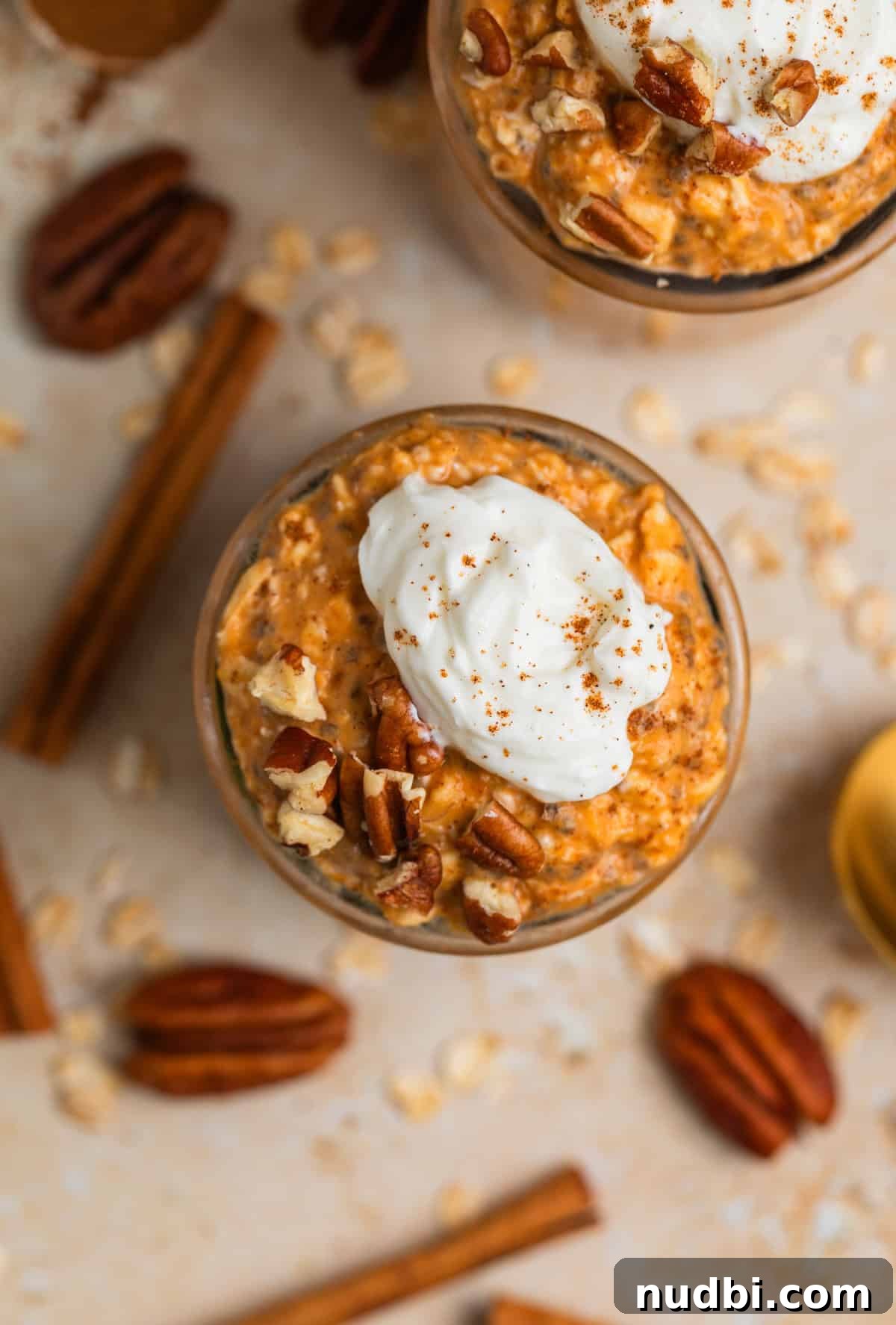 Pumpkin Pie Overnight Oats Recipe for Cozy Fall Breakfast 3 Overhead view of overnight oatmeal in jars with whipped cream and cinnamon topping.