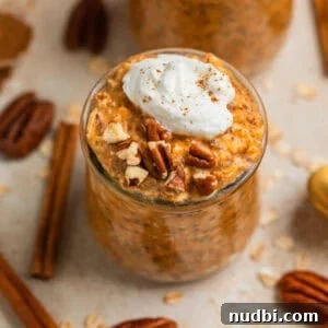 Pumpkin Pie Overnight Oats Recipe for Cozy Fall Breakfast 5 Pumpkin pie overnight oats in jar topped with whipped cream and cinnamon and pecans.