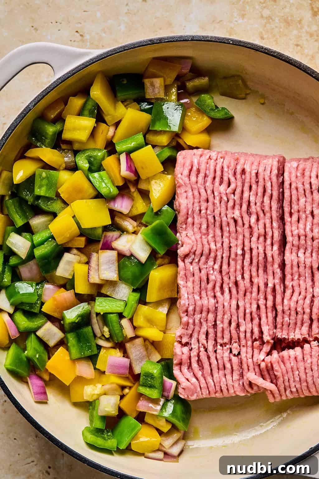 Weeknight Ground Turkey Skillet Dinner Recipe 5 Ground turkey added to skillet with sautéed onions and peppers.