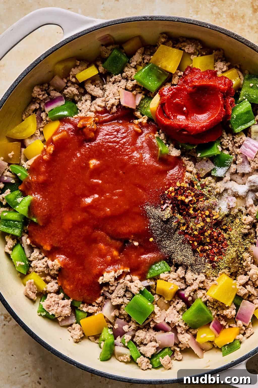 Weeknight Ground Turkey Skillet Dinner Recipe 7 Tomato sauce, tomato paste and seasonings added to pan with browned meat and peppers.