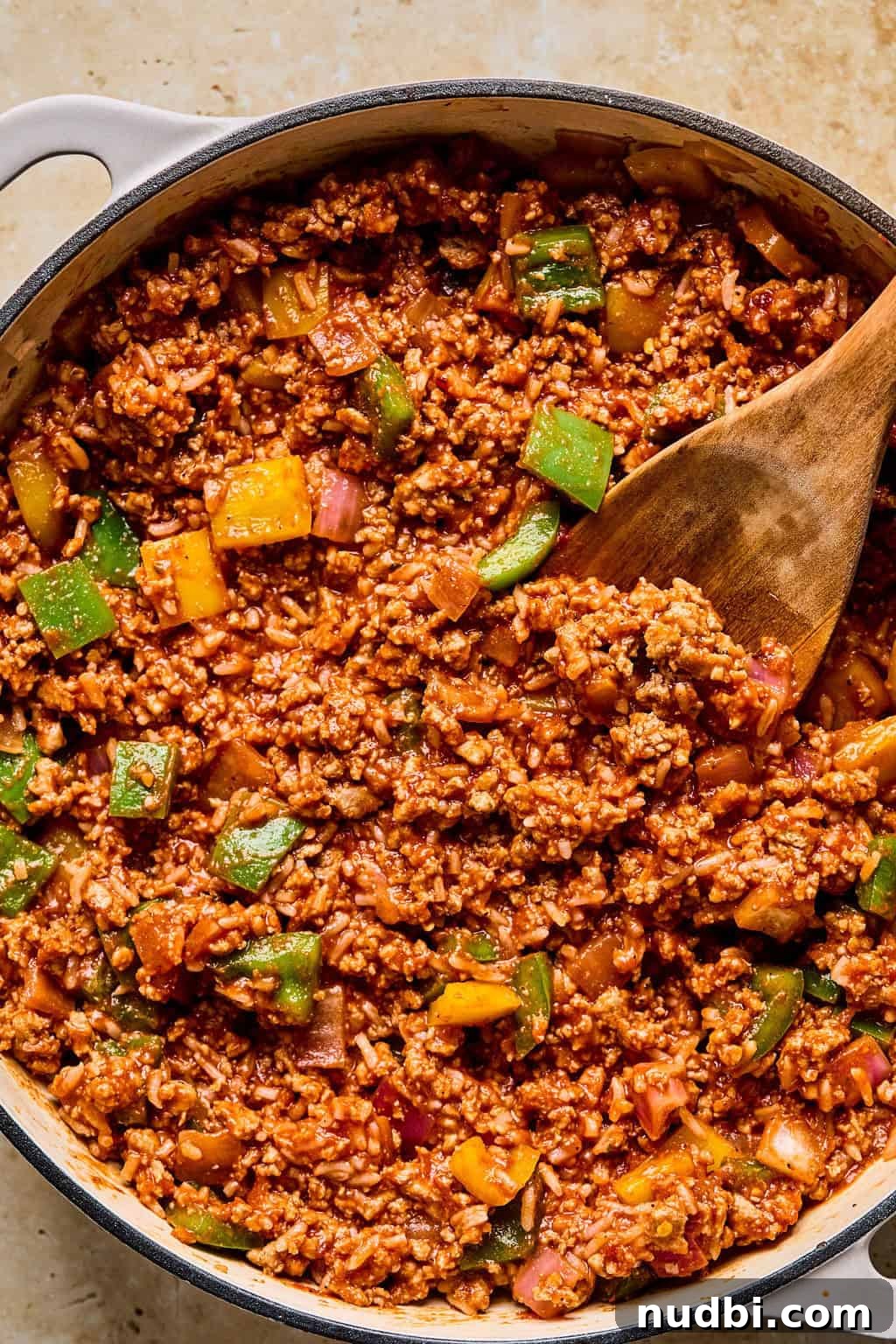 Weeknight Ground Turkey Skillet Dinner Recipe 9 Cooked skillet dinner with wooden spoon scooping in.