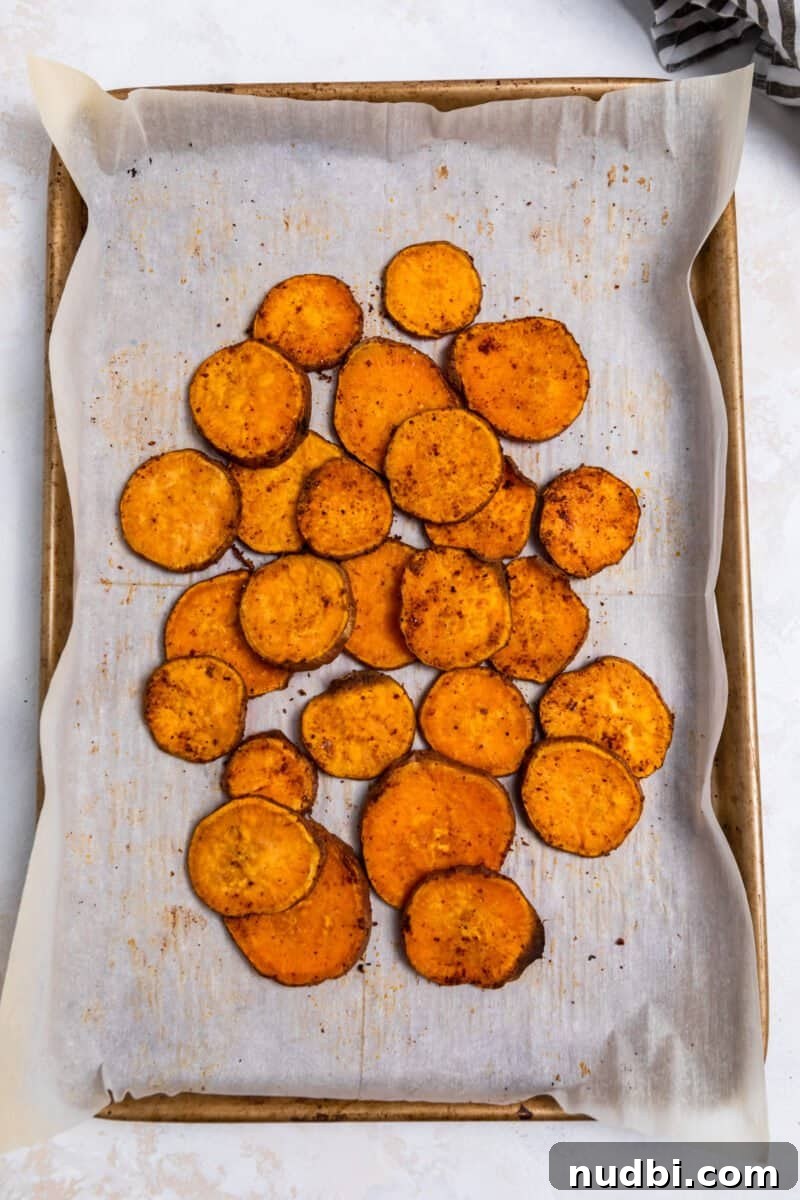 Sweet Potato Nachos with Creamy Avocado Sauce 5 Roasted sweet potato rounds pulled together on parchment lined baking sheet.