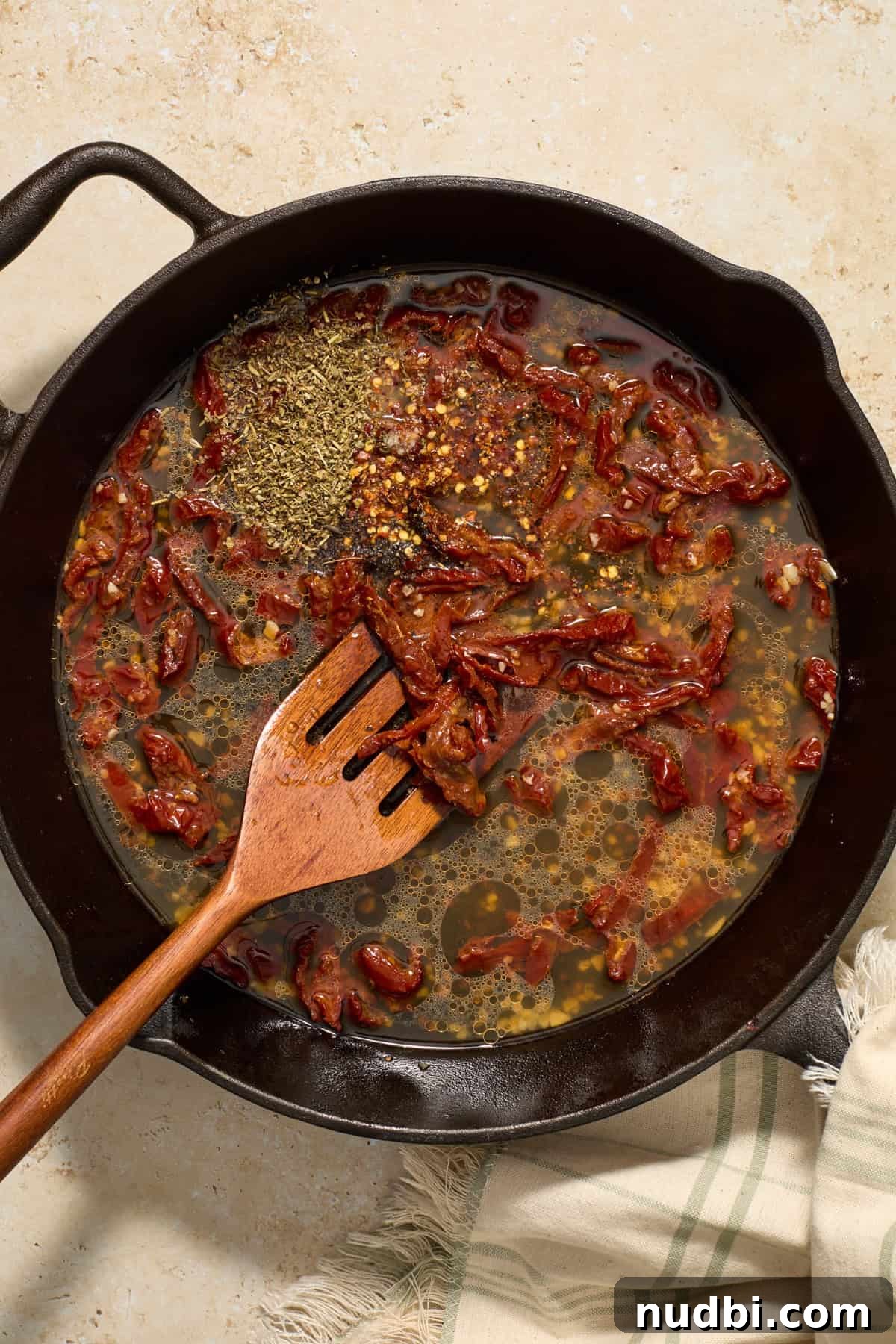 Sun-Dried Tomato Pasta with Italian Sausage Recipe 8 Broth and seasoning added to skillet with sun-dried tomatoes and garlic.