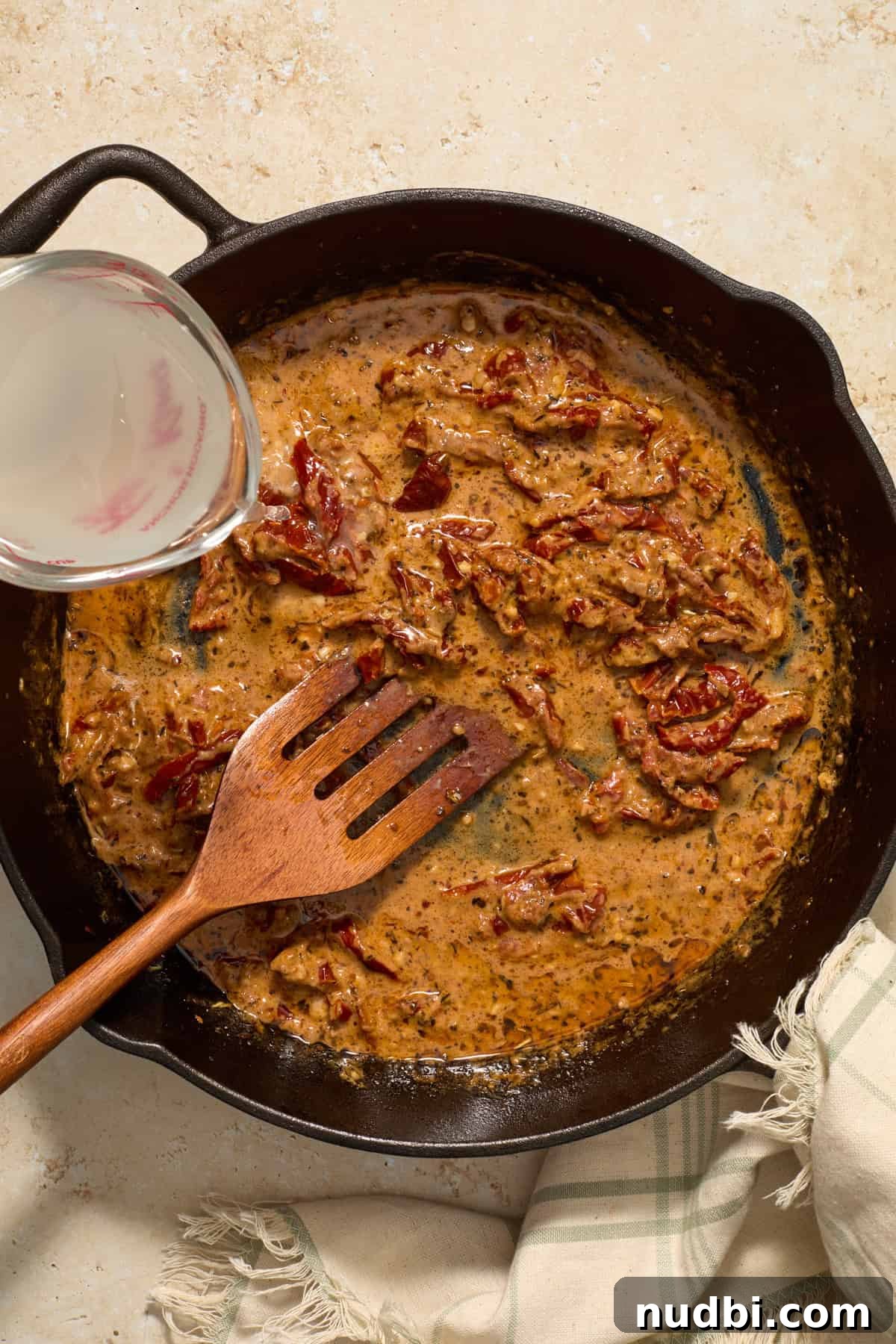 Sun-Dried Tomato Pasta with Italian Sausage Recipe 9 Creamy sun-dried tomato sauce with pasta water being added in.