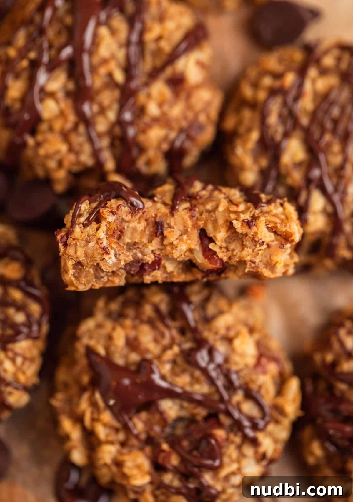 Peanut Butter Banana Oatmeal Breakfast Cookies That Keep You Full 7 Bite taken out of peanut butter banana oatmeal cookie with chocolate drizzle over top.