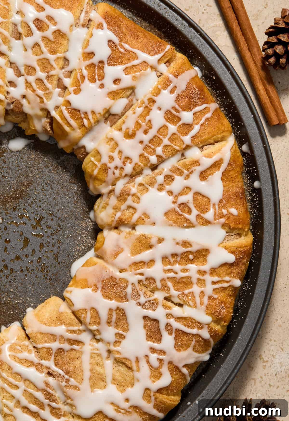 Cinnamon Crescent Roll Wreath Recipe — Festive Holiday Pastry 15 Close up view of cinnamon crescent wreath with icing drizzle over top.