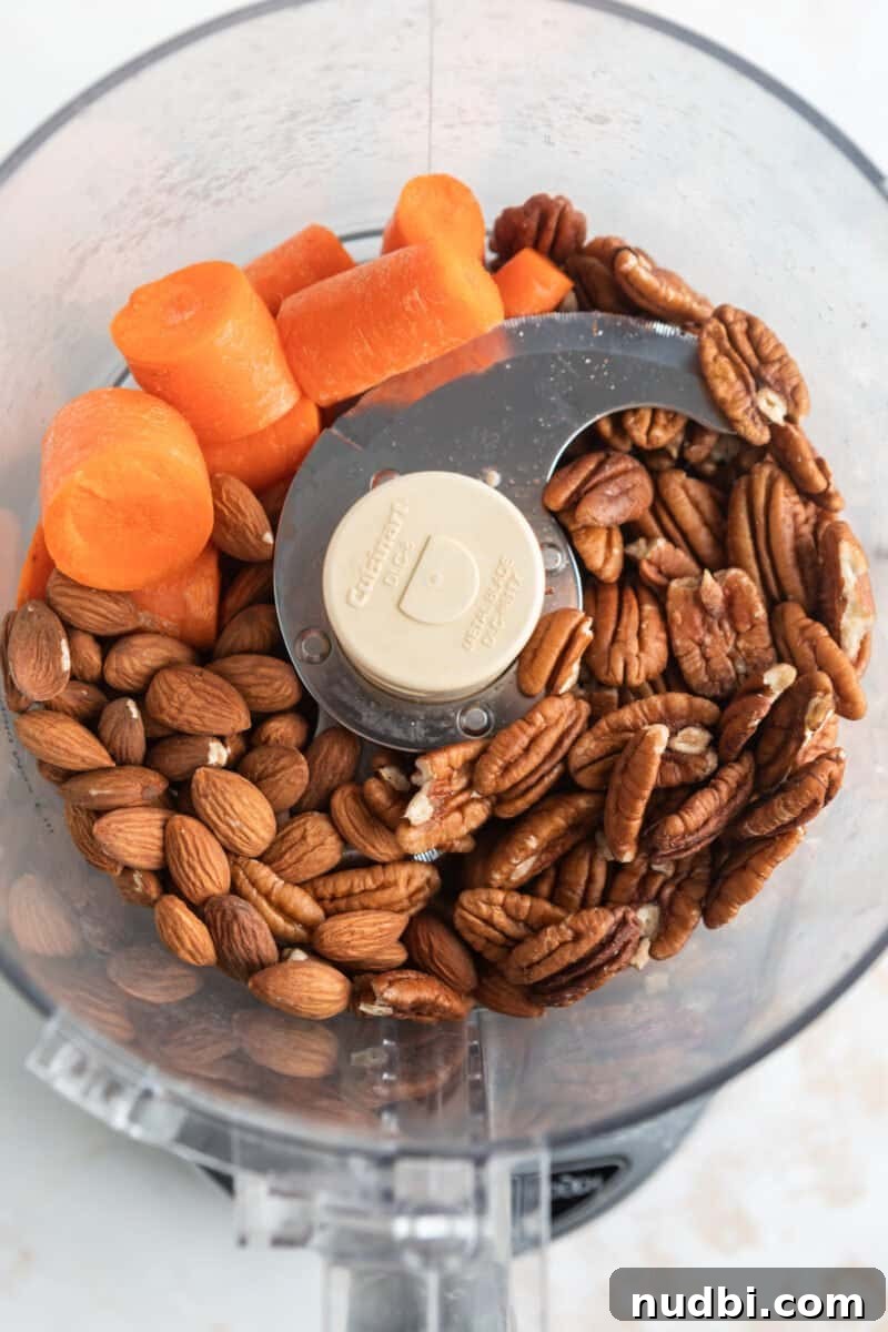 Carrot Cake Bites Recipe: Moist Mini Carrot Cake Balls 4 Carrot chunks, pecans, and almonds in food processor.