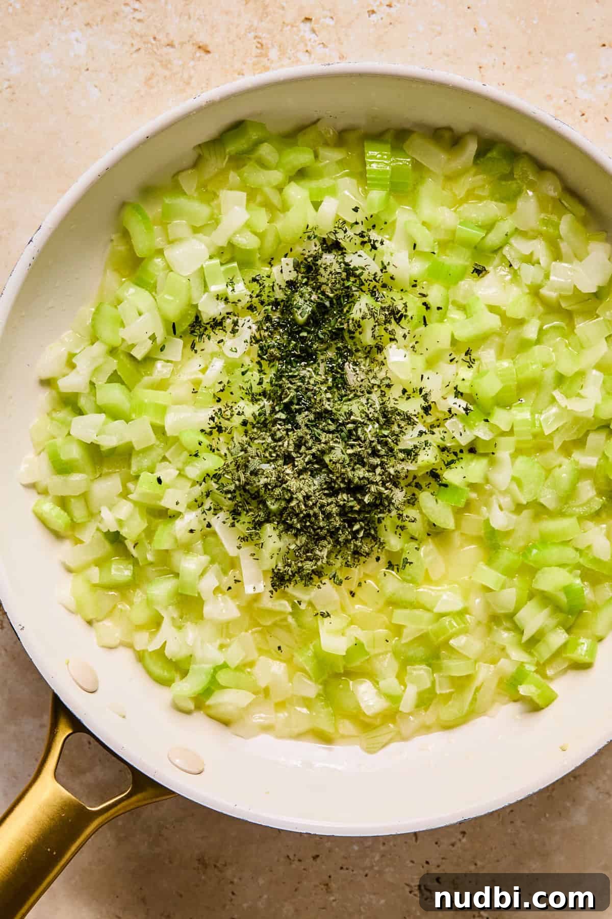 Apple and Sage Stuffing with Cranberries and Pecans 6 Butter, celery, onion and fresh herbs in pan.