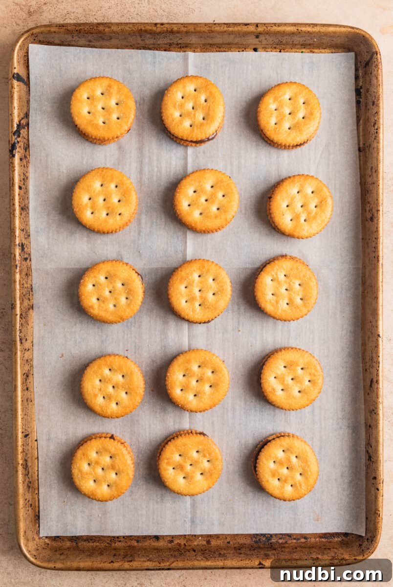 White Chocolate-Dipped Nutella Ritz Cracker Cookies 7 Ritz cracker cookies on cookie sheet.