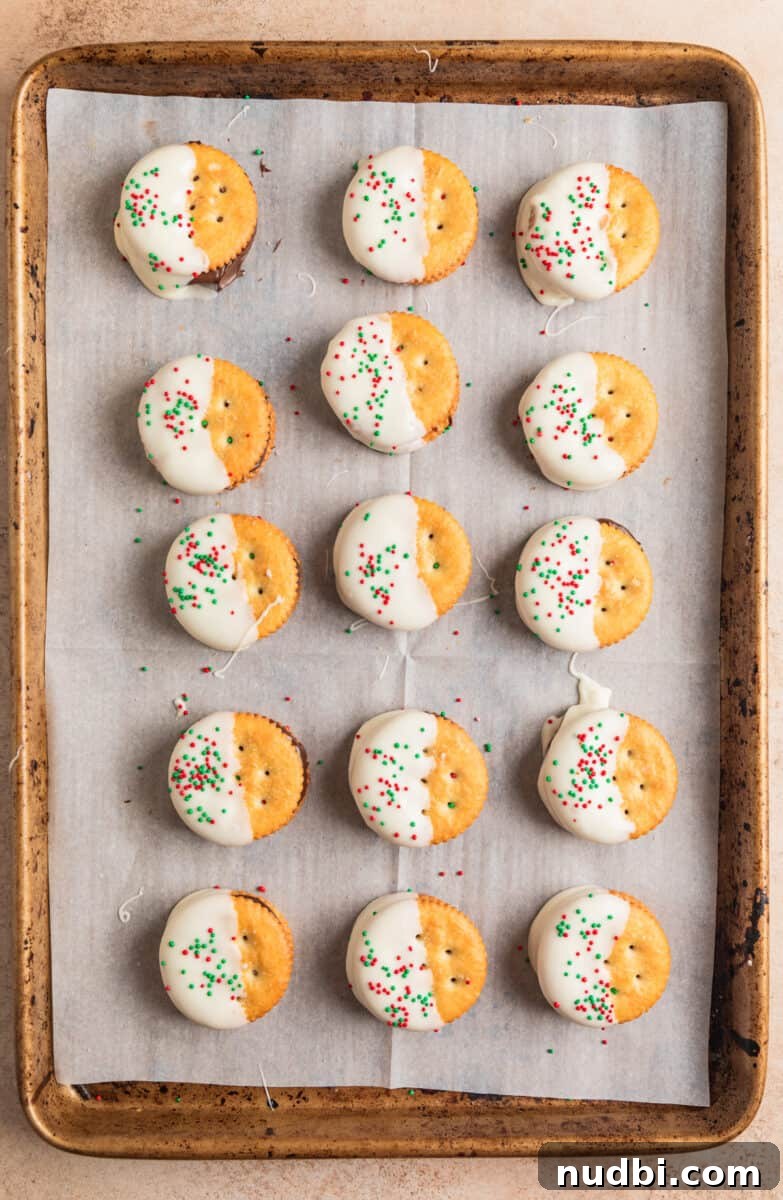 White Chocolate-Dipped Nutella Ritz Cracker Cookies 8 White chocolate dipped cracker sandwich cookies with red and green sprinkles on top.