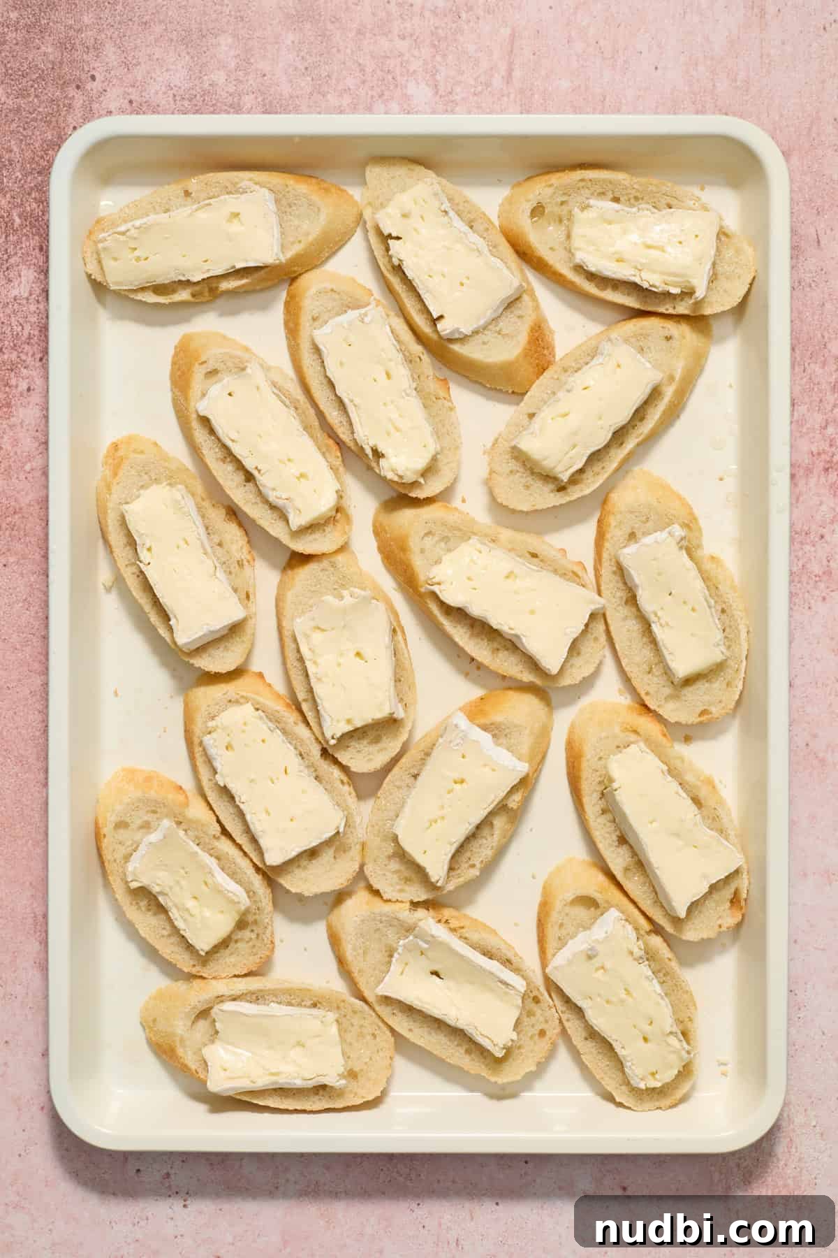 Cranberry Brie Crostini Recipe for Holiday Appetizers 6 Crostini slices with a piece of brie on each.