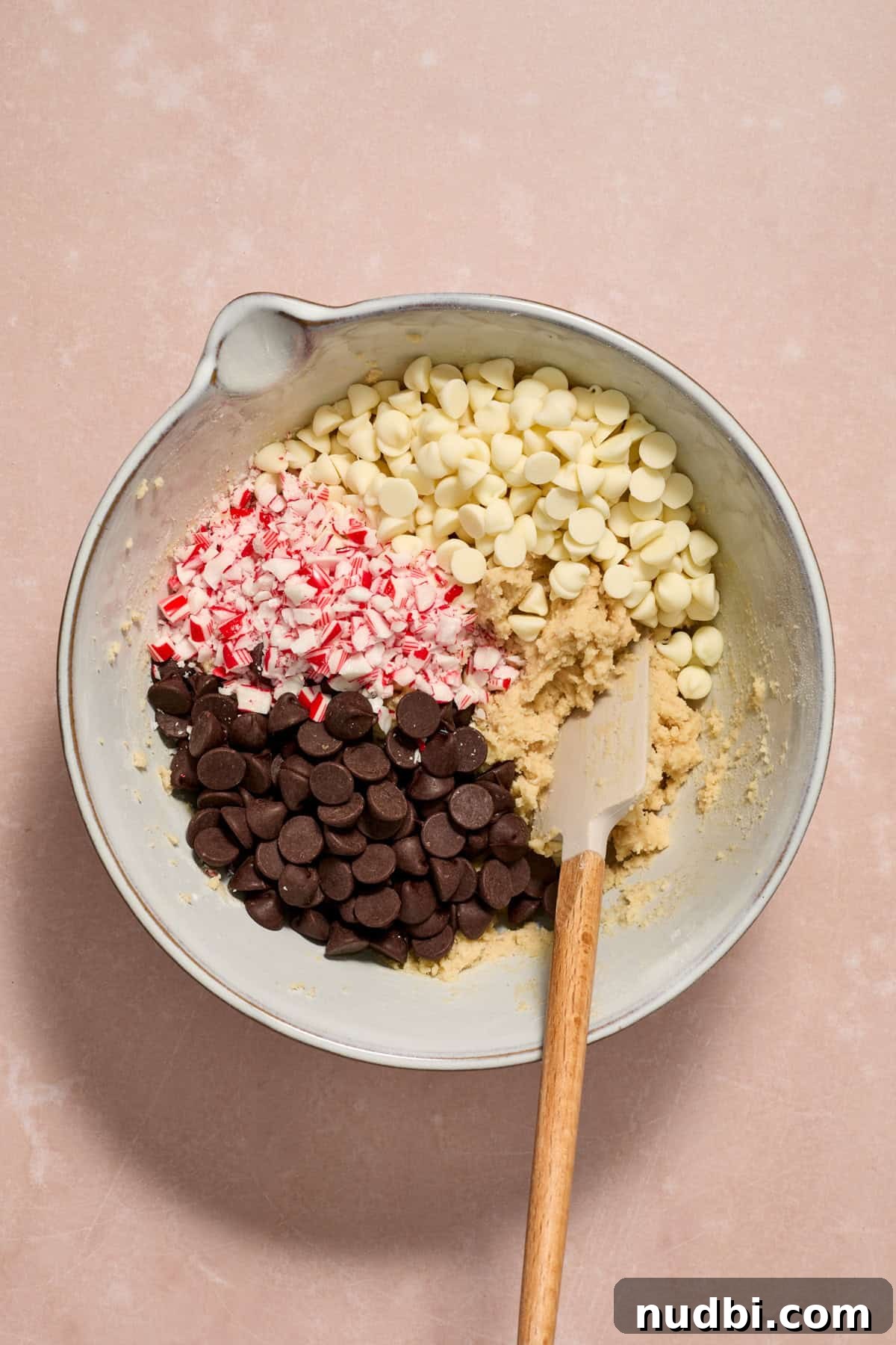 Peppermint Chocolate Chip Cookie Recipe: Festive Minty Cookies 11 White and dark chocolate chips and crushed peppermint candy canes added to mixing bowl.