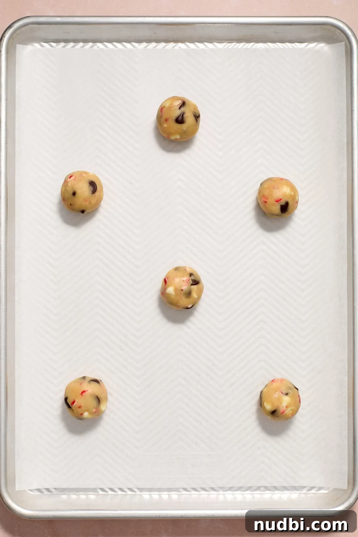 Peppermint Chocolate Chip Cookie Recipe: Festive Minty Cookies 13 Rolled cookie dough on parchment lined pan.