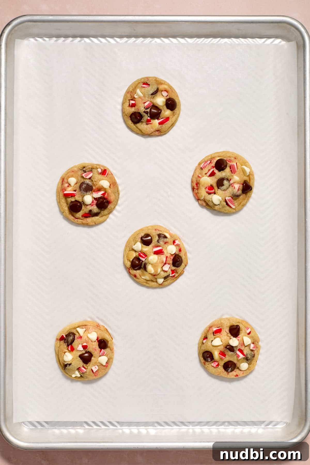 Peppermint Chocolate Chip Cookie Recipe: Festive Minty Cookies 14 Baked peppermint chocolate chip cookies on pan.