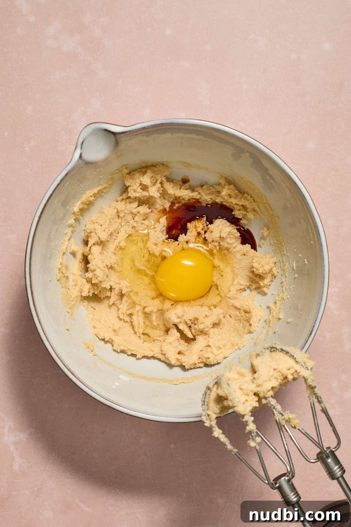 Peppermint Chocolate Chip Cookie Recipe: Festive Minty Cookies 7 Egg and vanilla added to mixing bowl.