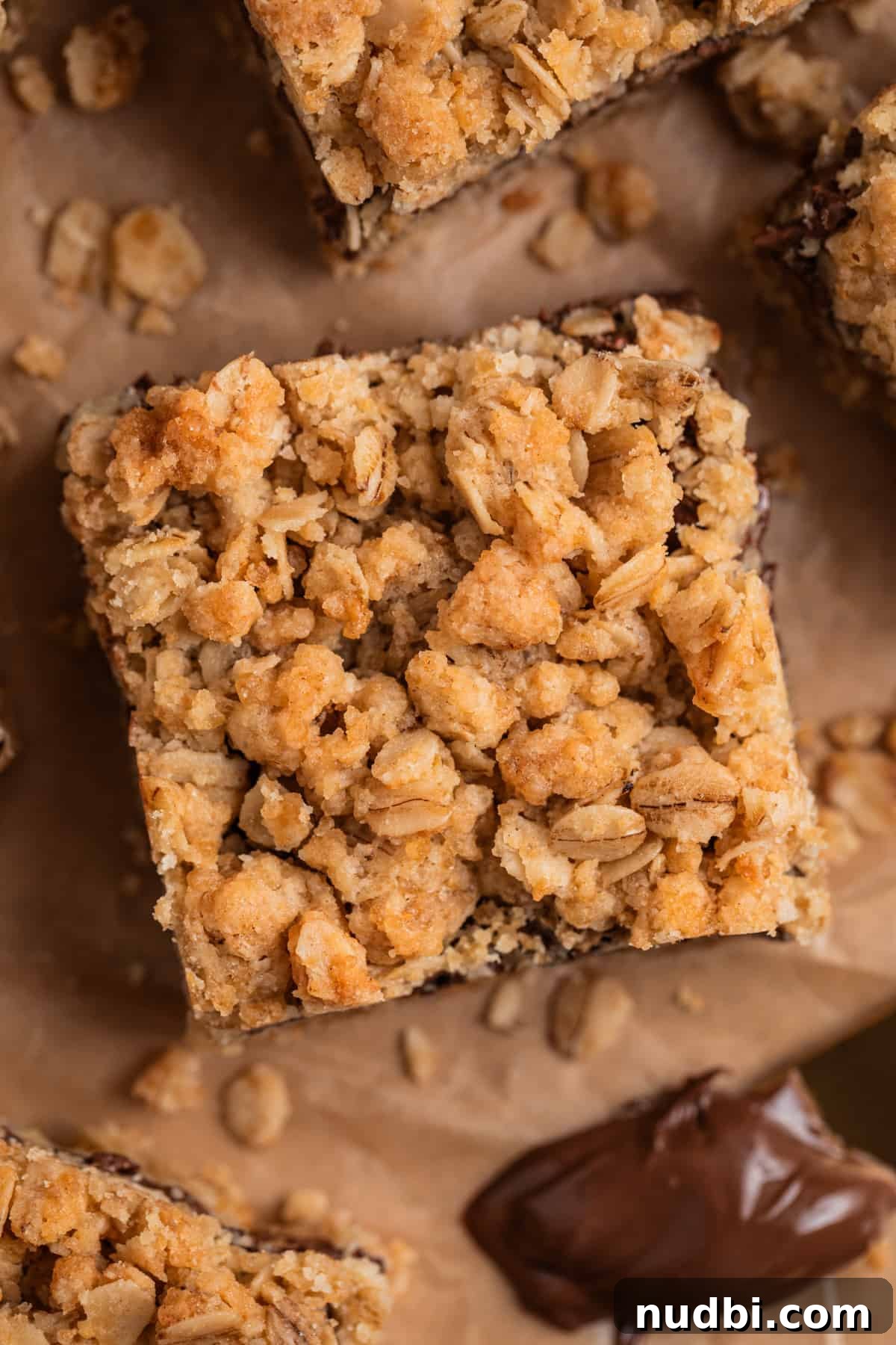 Nutella Oatmeal Bars Recipe — Chewy Hazelnut Oatmeal Squares 3 Overhead view of Nutella oat bars with knife that has Nutella on it.