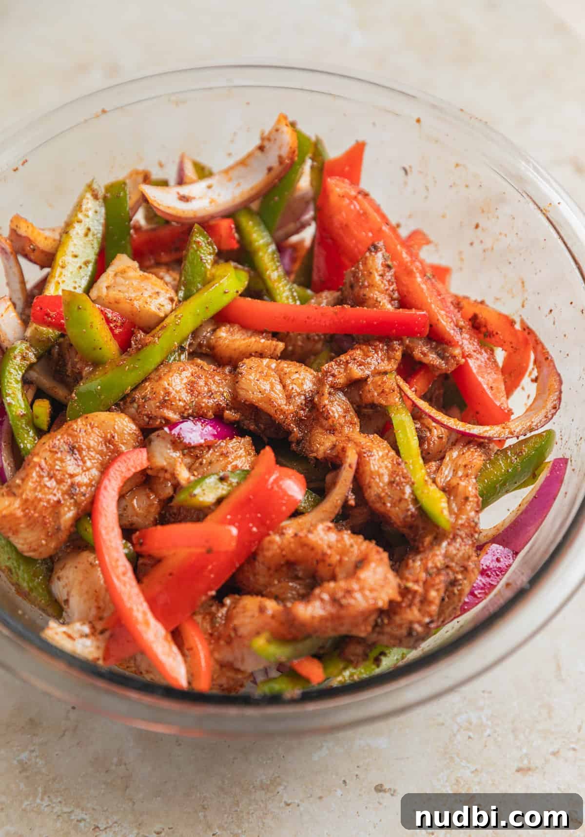 Honey-Lime Baked Chicken Fajitas Recipe for Flavorful Weeknights 6 Chicken fajita mixture in bowl with marinade before being cooked.