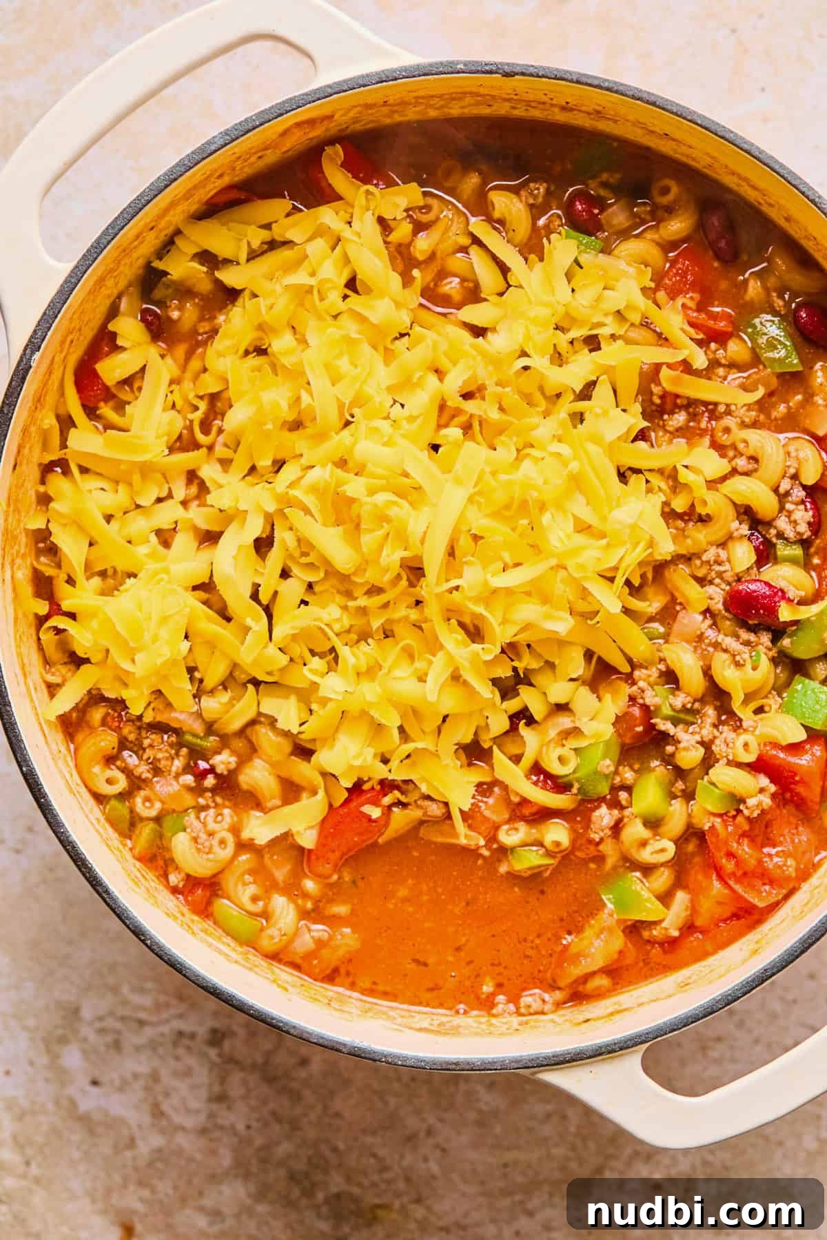 One-Pot Chili Mac: Cheesy Beef Skillet Dinner 11 Cheese added to pot of chili and macaroni.